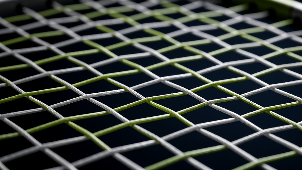 Close-up of a tightly strung badminton racket string bed